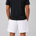 ST Padel Mesh Drawstring Shorts. A man wearing white athletic mesh shorts and a black t-shirt, shown from the back against a light gray studio background.