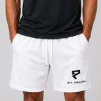 ST Padel Mesh Drawstring Shorts. White athletic shorts with a black St. Padel logo on the left leg, worn by a model in a black shirt against a light gray background.