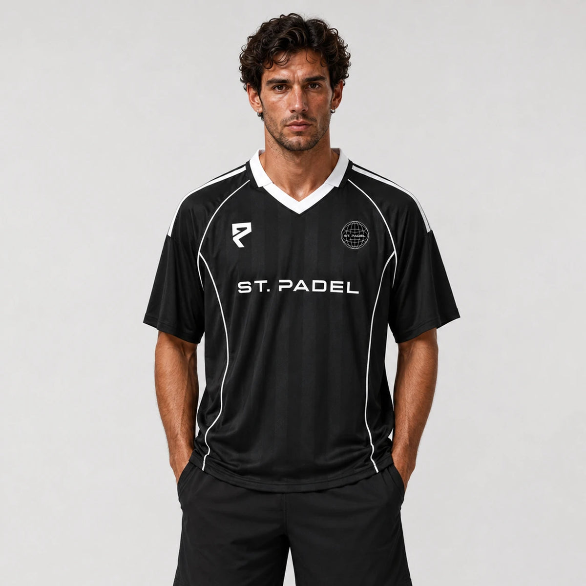 St Padel Shadow Stripe Jersey. A man modeling a black short-sleeve soccer jersey with white accents, featuring the text 'ST. PADEL' across the chest and a circular club crest on the left chest, set against a plain light gray background.